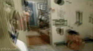 woman runs and slides on a kitchen floor, crashing into cabinets