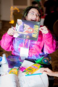 2016 Sex Geek Salon attendee holds SheVibe's NSFW coloring book in front of their face
