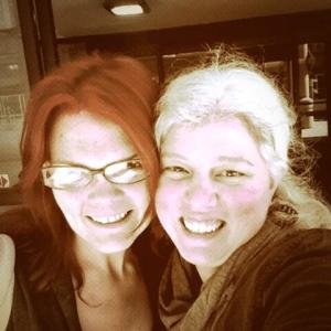 JoEllen in brown glasses posing with a woman with white hair