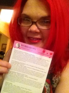 JoEllen holding a class schedule from Good Vibrations