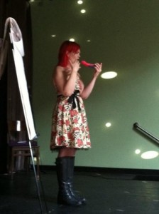 JoEllen onstage about to put a dildo in her mouth