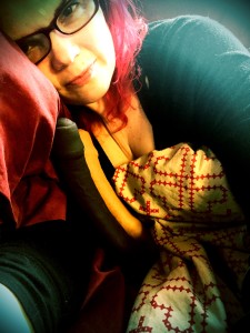 JoEllen cuddling with 2 Tantus Uncut dildos