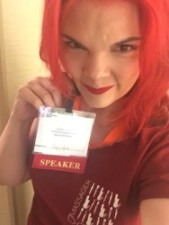 JoEllen posing with a badge reading "speaker"