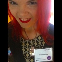 JoEllen wearing a name badge for the Playground Conference