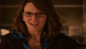 Dark-haired woman (Liz Lemon from 30 Rock) sticking her tongue out and giving a thumbs-down