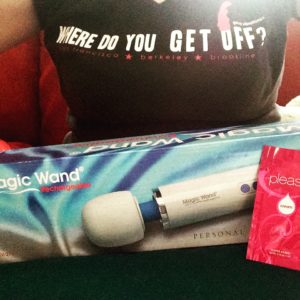 Torso wearing t-shirt reading "where do you get off?" with a Magic Wand Rechargeable box in front of it.