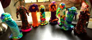 8 brightly colored crocheted dildo cozies