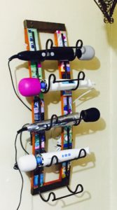 Wine rack holding (from top to bottom) Original Doxy Wand, Magic Wand Original, Doxy Die Cast, Magic Wand Rechargeable