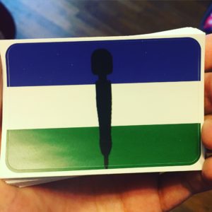 Stickers featuring a flag made up of three horizontal stripes: Blue, white, and green, with the black silhouette of a Doxy wand over them
